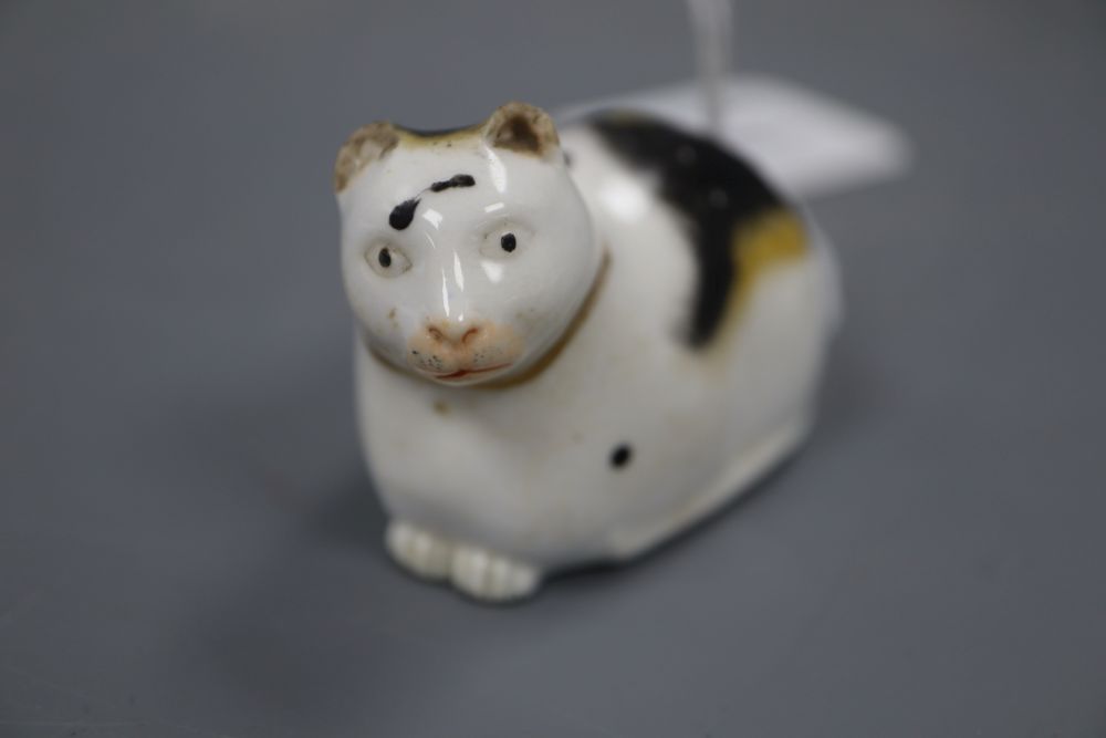 A Derby porcelain figure of a recumbent cat, c.1830, incised 1 to the base